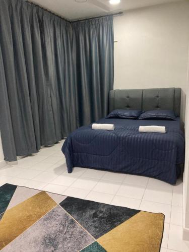 a bedroom with a blue bed in a room at ABSYAR HOMESTAY SELASIH in Putrajaya