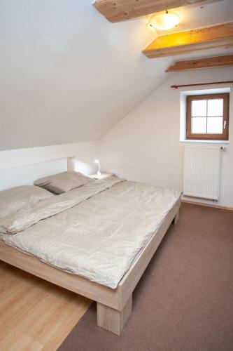 a bedroom with a large bed in a attic at Apartmány NaVyhlídce in Znojmo