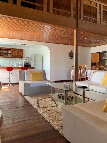 a living room with a couch and a table at Villa Eden Wood in Ivato