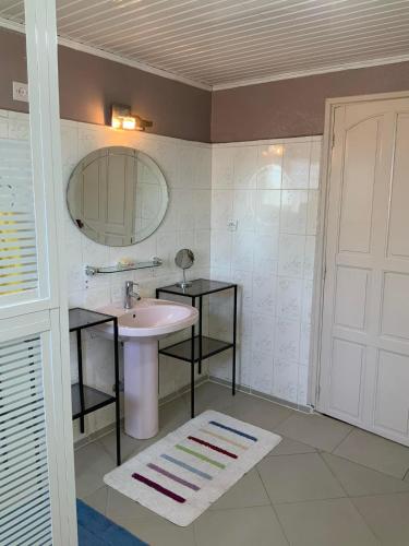 a bathroom with a sink and a mirror at Villa Eden Wood in Ivato