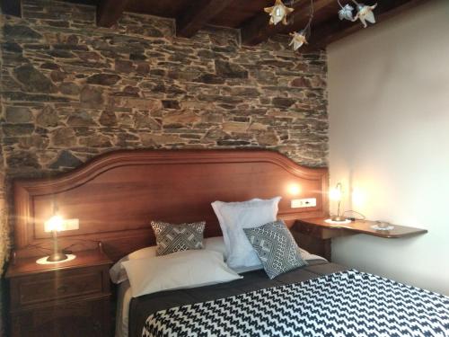 Postel nebo postele na pokoji v ubytování La Posada de Oscos