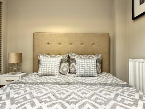 a bedroom with a large bed with pillows at LuxApart Kalisz Loft in Kalisz