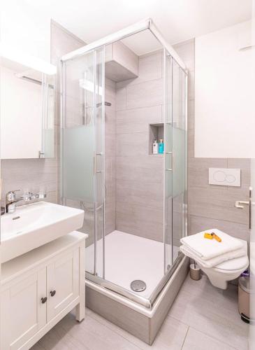 a bathroom with a shower and a toilet and a sink at one bedroom apartment in trendy Zurich West in Zürich