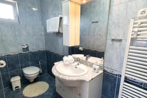 a bathroom with a sink and a toilet at Anett Villa in Hévíz