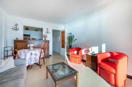 un salon avec des chaises rouges et une table dans l'établissement Appartement cosy à Cannes - 40 m² avec balcon et vue mer, à Cannes