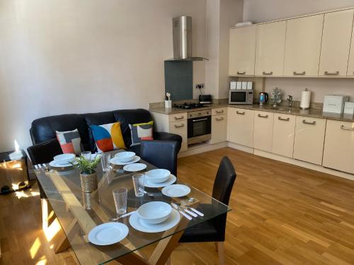 a dining room and kitchen with a table and chairs at Sight Flats - SF01 - One Bedroom in London