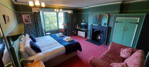 a bedroom with a bed and a couch and a chair at Bron-Y-Graig in Corwen