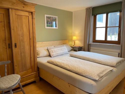 a bedroom with a large bed with a window at Ferienhof Wolfrum in Berg