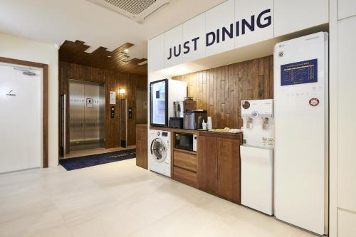 a just dining sign in a kitchen with a refrigerator at JustSleep Namyangju Dasan in Namyangju