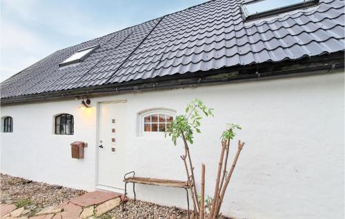 a white house with a bench in front of it at Gorgeous Home In Rydebäck With Wifi in Rydebäck