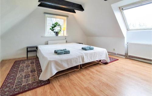 a bedroom with a bed with two pillows on it at Gorgeous Home In Rydebck With Wifi in Rydebäck