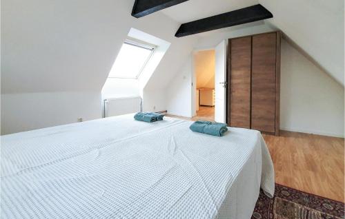 a bedroom with a large white bed with two blue pillows on it at Gorgeous Home In Rydebäck With Wifi in Rydebäck