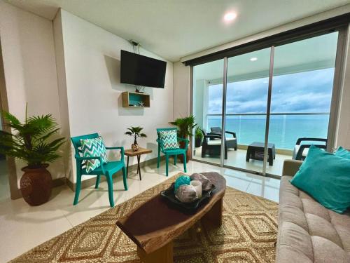 a living room with a view of the ocean at Cartagena Palmetto Beach Bella Vista in Cartagena de Indias