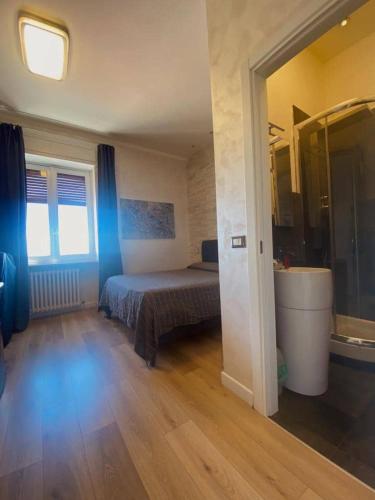 a bedroom with a bed in a room with wooden floors at A 2 PASSI da in Foggia