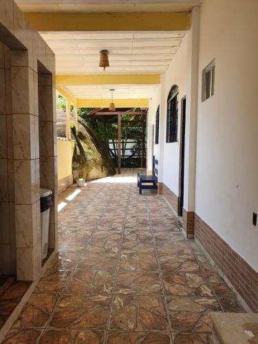 an empty hallway of a house with a tile floor at Pousada Korui in Abraão