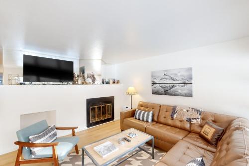 a living room with a couch and a fireplace at Revitalize in Vail in Vail