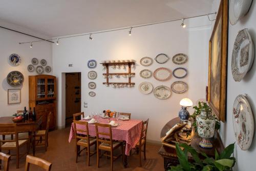 a dining room with a table and plates on the wall at Campanacci Agriturismo in Faenza