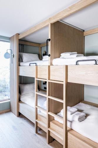 a bunk room with four bunk beds in it at Mollie's Motel & Diner Oxfordshire in Faringdon