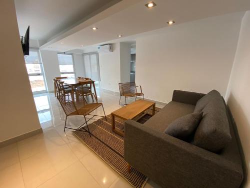 a living room with a couch and a table at HAUS APARTAMENTOS in Salta