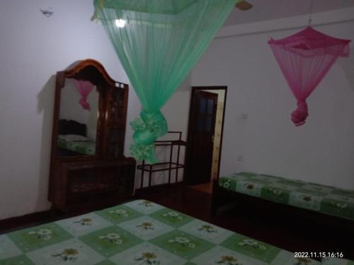 a bedroom with a bed and a mirror at Ancient Tree in Mirissa