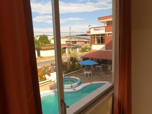 a view of a swimming pool from a window at Hotel Palmar del Río Premium in Archidona