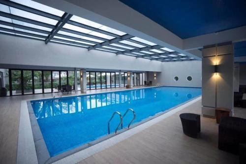 a large swimming pool in a building at Rio Ha Long Homestay - Green Bay Garden in Ha Long