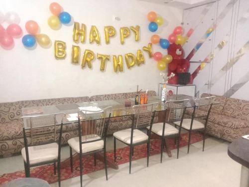 a table with balloons and a happy birthday sign at City Palace in Panchkula