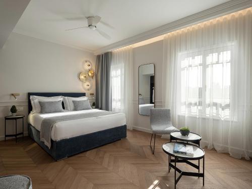 a bedroom with a bed and a living room at Riviera Suites in Chania
