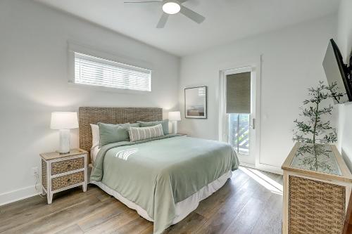 a white bedroom with a bed and a ceiling fan at Beaches and Bunkers in Port Aransas