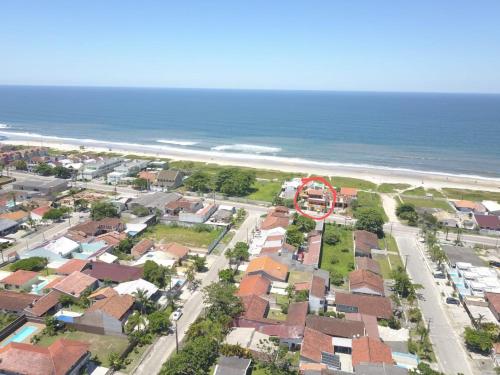 an aerial view of a town with houses and the beach at Apartamentos na Quadra do Mar in Guaratuba
