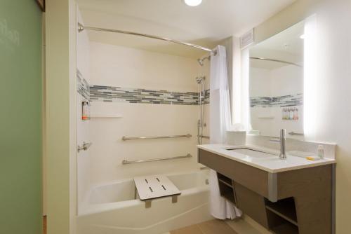 a white bathroom with a sink and a shower at EVEN Hotel Rockville - Washington, DC Area by IHG in Rockville