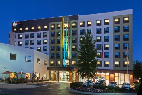 a large building with cars parked in front of it at EVEN Hotel Rockville - Washington, DC Area by IHG in Rockville