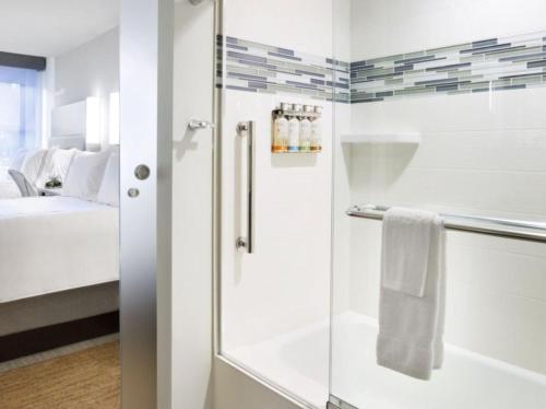 a bathroom with a shower and a sink at EVEN Hotel Rockville - Washington, DC Area, an IHG Hotel in Rockville