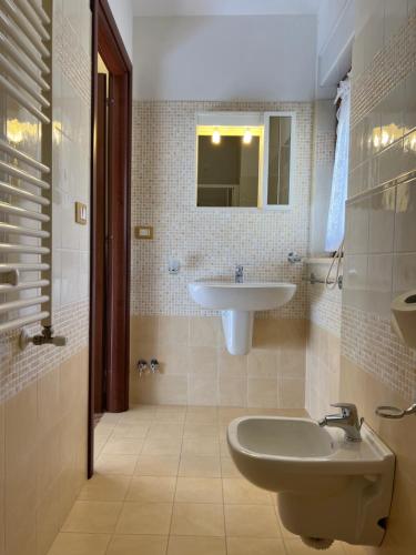 a bathroom with a sink and a toilet and a mirror at B&B Il Girasole in Castel di Sangro