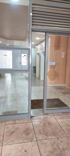 an empty room with a glass door in a building at Apartment 2 bedrooms Central Location in Ashdod