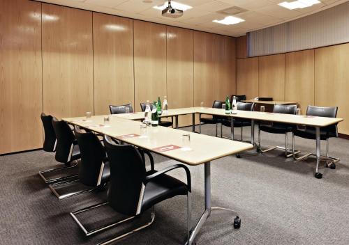 a conference room with long tables and chairs at voco Reading in Reading
