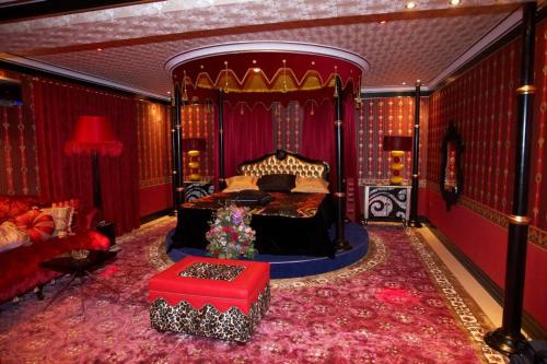 a bedroom with a large bed and a red room at Hotel Priamos-Αdults Only in Athens