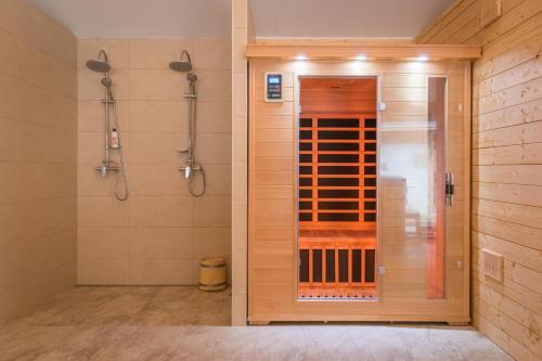 a bathroom with a shower and a walk in shower at Vila Kotlina - High Tatras 2023 in Vysoké Tatry
