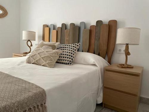 a bedroom with a bed with a wooden headboard at CASA MAMA CARINA in Agüimes