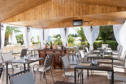 a dining room with tables and chairs in a restaurant at Fattoria Maremmana in Marina di Grosseto