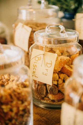 a group of jars filled with different types of food at Vigla Hotel in Aegiali