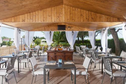 a group of tables and chairs in a restaurant at Fattoria Maremmana in Marina di Grosseto