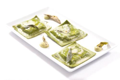 a plate of green jade jewelry on a white plate at Fattoria Maremmana in Marina di Grosseto