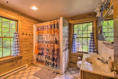 a bathroom with a shower and a sink and a toilet at Cozy Riverfront Getaway Fishing On-Site! in Lacon