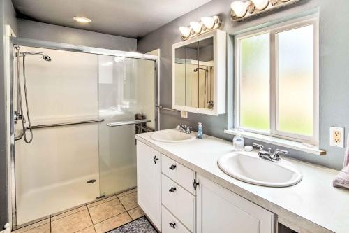 a bathroom with two sinks and a shower at Quaint Coquille Getaway Near Beaches and Parks! in Coquille