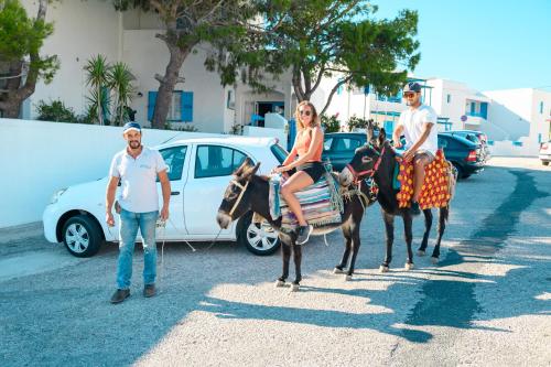 a man and a woman riding on a donkey at Vigla Hotel in Aegiali