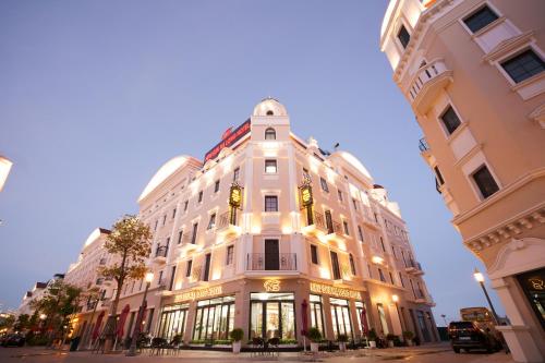 a large white building on a city street at Sunland Halong Hotel and Restaurant in Ha Long