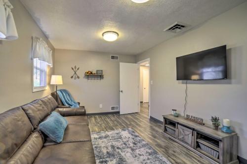 a living room with a couch and a flat screen tv at Near Mines and Meadows Spacious Home with Game Room in Beaver Falls