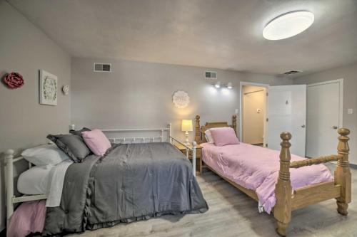 a bedroom with two beds with pink and gray sheets at Near Mines and Meadows Spacious Home with Game Room in Beaver Falls
