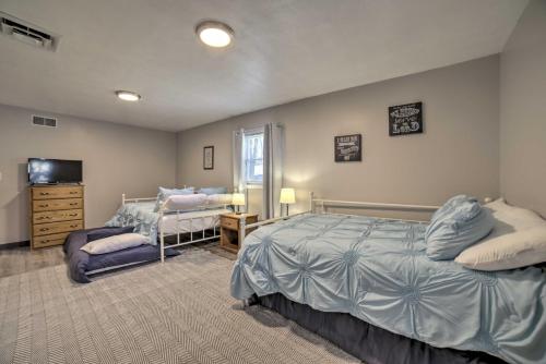 a bedroom with two beds and a television in it at Near Mines and Meadows Spacious Home with Game Room in Beaver Falls